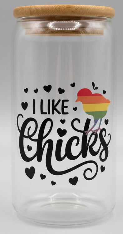 Clear glass cup with wooden lid and 'I Like Chicks' text and rainbow heart design on a light blue background.